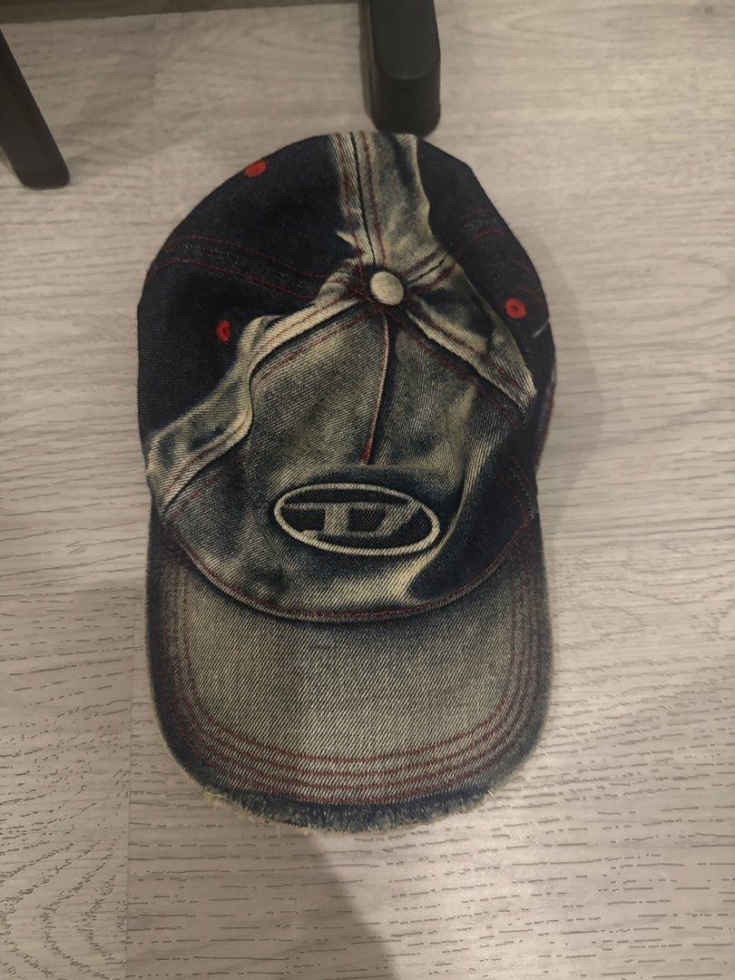 Diesel Distressed Denim Baseball Cap with Oval Logo (Category: Caps & Hats) located in Makati City. Submitted by stallionmegx (Listing ID 1467305688, Image 1). Description: - Brand: Diesel - Style: Baseball cap / strapback - Material/Wash: Dark acid wash denim - Details: Distressed finish with frayed brim and red contrast stitching - Branding: Embroidered oval logo on front - Fit: Adjustable strap for custom sizing - Condition: Brand new / Like n