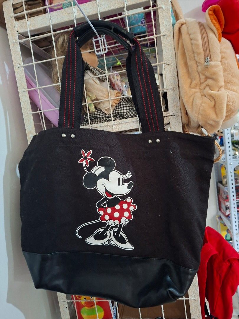 Disney Minnie Mouse Tote Bag (L) (Category: Luxury Bags & Wallets) located in Manila. Submitted by happywindmarlyn (Listing ID 1467228270, Image 1). Description: - Disney Minnie Mouse Tote Bag -Black canvas tote bag paired with a smooth, glossy black synthetic base reinforcement at the bottom. -large-capacity,approximately 14 to 16 inches in width and 12 to 14 inches in height ( excluding the handle..