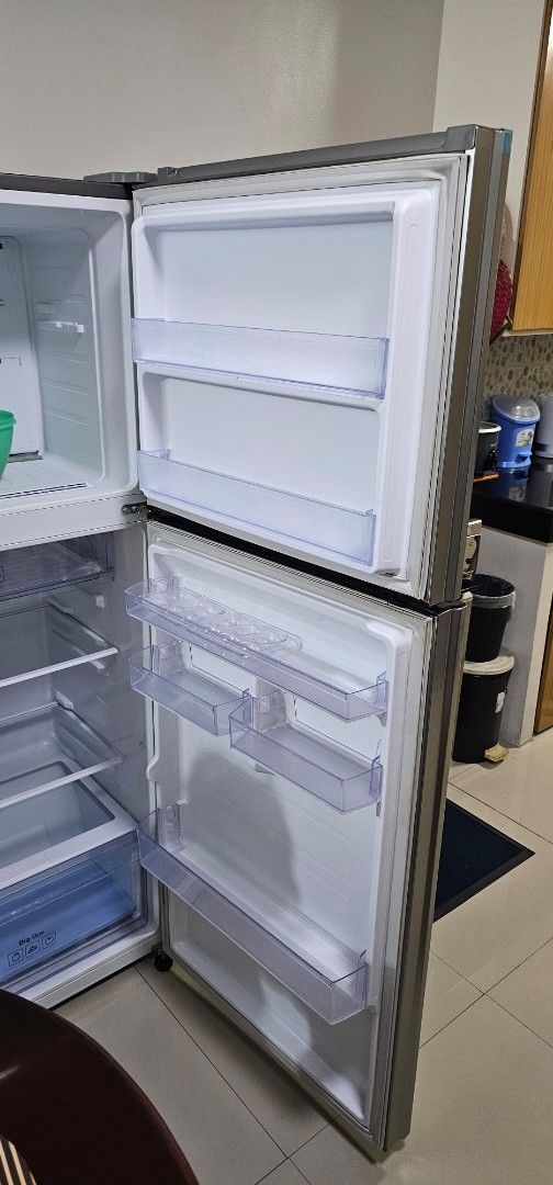 Double Door Refrigerator Fridge Clean Interior Storage (Category: Refrigerators and Freezers) located in Manila. Submitted by ipmansifu (Listing ID 1467171839, Image 1). Description: - Type: Double door fridge with stylish stainless steel exterior - Interior: Clean white finish with adjustable shelves and clear door bins - Capacity: Spacious storage for food, drinks, and condiments - Condition: Main fridge is working cold as new. Main issue is th