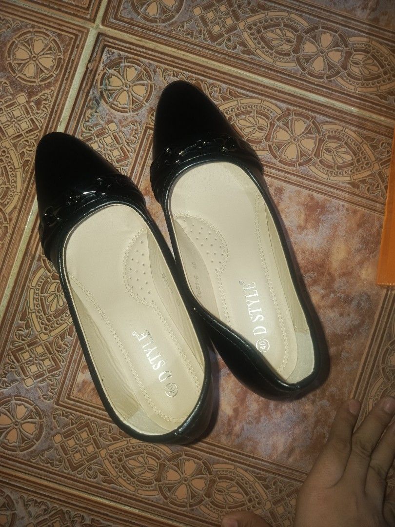 DStyle Black Shoes size 40 bundle (Category: Heels) located in Malasiqui. Submitted by shop.bea (Listing ID 1467286351, Image 2). Description: - Brand: D STYLE - Color: Black - Style: Pointed toe heels with slip-on design and decorative front buckle strap - Heel: Stable block heel for comfortable walking - Size: 40 (marked on insoles and outsoles) - Condition: Brand new, clean soles with zero wear marks - Inclusion: Original orange D STYLE shoe b