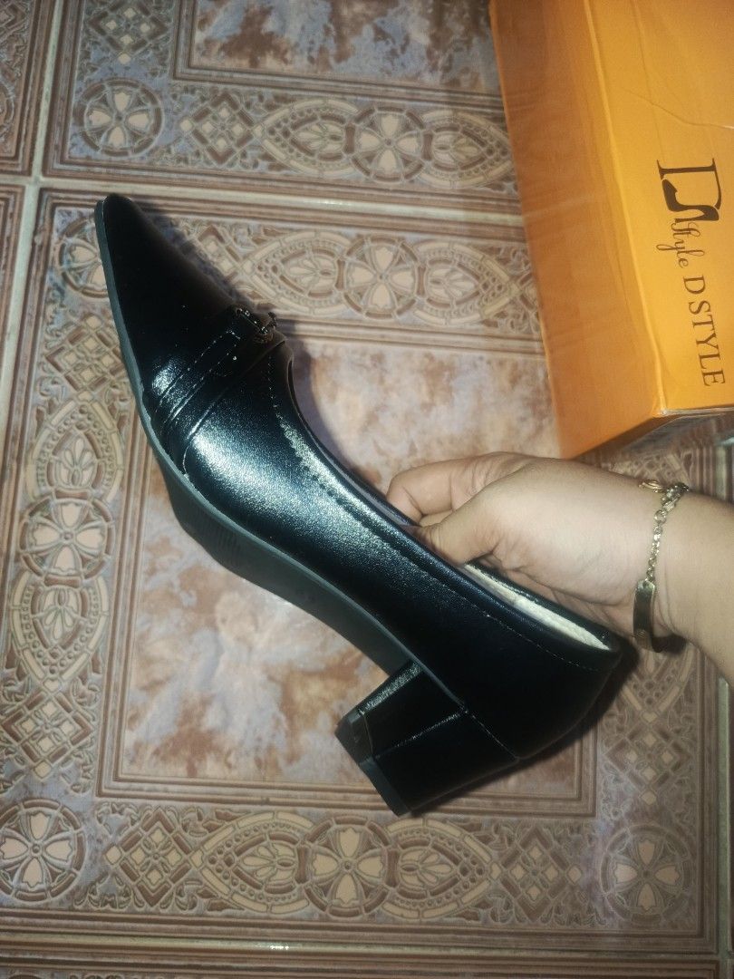 DStyle Black Shoes size 40 bundle (Category: Heels) located in Malasiqui. Submitted by shop.bea (Listing ID 1467286351, Image 3). Description: - Brand: D STYLE - Color: Black - Style: Pointed toe heels with slip-on design and decorative front buckle strap - Heel: Stable block heel for comfortable walking - Size: 40 (marked on insoles and outsoles) - Condition: Brand new, clean soles with zero wear marks - Inclusion: Original orange D STYLE shoe b