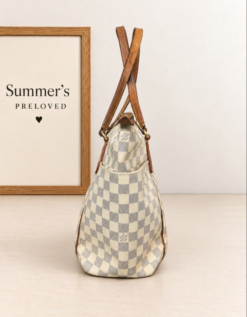 Elvira Damier Azur Tote bag (Category: Tote Bags) located in Taguig. Submitted by summers.preloved (Listing ID 1467282496, Image 2). Description: 👜 BAG DETAILS • Damier Azur coated canvas: The signature checked exterior gives this tote its recognizable look and gently textured finish. • Leather handles and trim: The design features vachetta cowhide leather, with this piece showing a deep caramel-brown patina. Contrast stitching and leather pipin