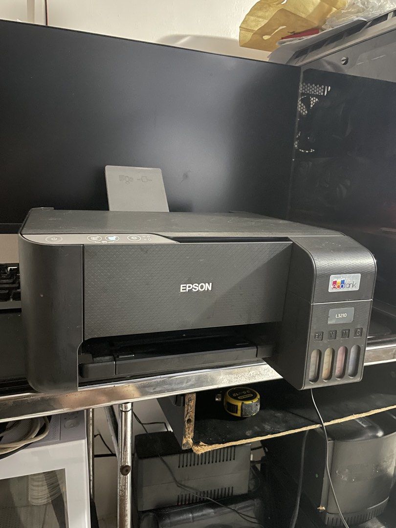 Epson EcoTank L3210 All-in-One Ink Tank Printer (Category: Printers, Scanners & Copiers) located in Manila. Submitted by designerbr74373 (Listing ID 1467241933, Image 2). Description: - Model: Epson EcoTank L3210 (Black) - Condition: Good working order with minor dust from normal desktop use - Features: Built-in front ink tanks for easy level monitoring - Inclusions: Power cable attached - Ideal For: Home office documents and everyday photo print