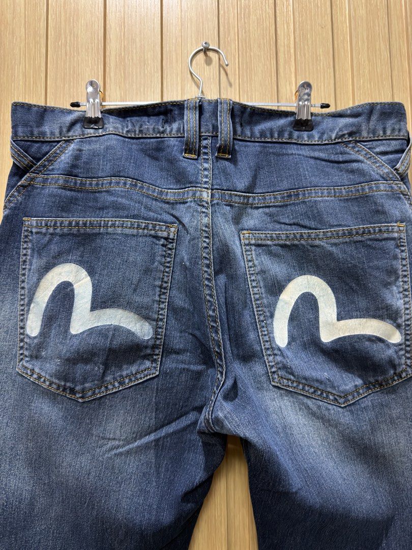 Evisu Dark Wash Denim Jeans Size 32 (Category: Jeans) located in Bacoor. Submitted by preloved_with_love_ (Listing ID 1467253519, Image 3). Description: - Brand: Evisu - Style: Dark wash denim jeans with regular fit - Size: Waist 32 - Details: Iconic painted seagull logo on back pockets, button fly with branded hardware, and unique geometric printed inner lining - Condition: Ready to wear, classic street style staple.