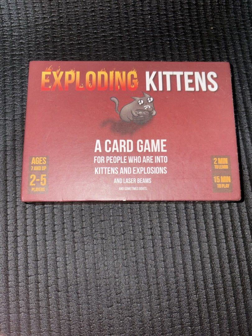 Exploding Kittens Card Game with Imploding Kittens DLC (Category: Board Games & Puzzles) located in Quezon City. Submitted by colonelbirb (Listing ID 1467351369, Image 1). Description: - Game: Exploding Kittens by Elan Lee, Matthew Inman, and Shane Small - Players: 2 to 5 players - Age: 7 years old and up - Playtime: Approx. 15 minutes per round - Condition: Complete with original box, plastic insert tray, full deck of cards, and instruction card