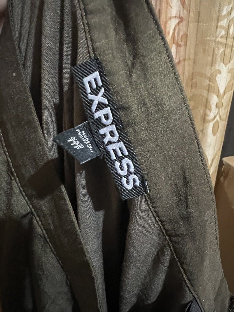 Express Olive Green High Low Midi Skirt (Category: Skirts) located in Cabanatuan. Submitted by imported2023 (Listing ID 1467170543, Image 2). Description: - Brand: Express - Color: Olive green - Size: XXS - Style: Midi length with a high-low hemline and flowy drape - Details: Lightweight fabric and simple waistband - Origin: Made in Philippines - Condition: Great piece for mixing and matching tops.