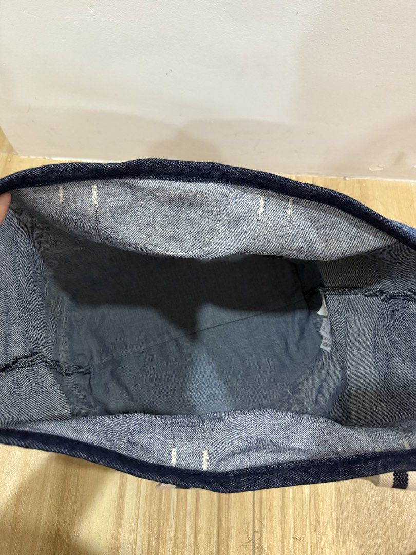 Felix the Cat Denim Tote Bag (Category: Tote Bags) located in Taguig. Submitted by closet.ny (Listing ID 1467189618, Image 3). Description: - Condition: Clean fabric, no major wear - Material: 100% cotton (© 2021 DWA LLC) - Design: Dark denim base and trim with a cool Felix University front pocket patch - Straps: Stylish white and navy striped shoulder straps - Interior: Spacious and practical for everyday essentials RFS: A gift but not used.