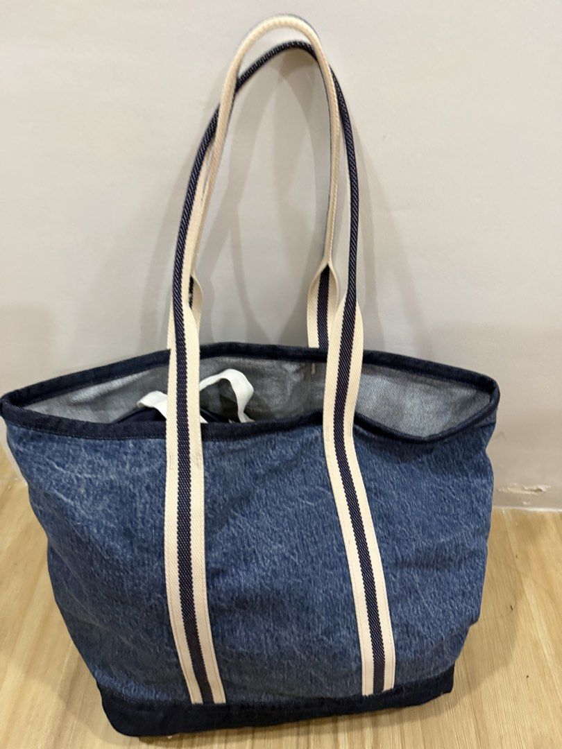 Felix the Cat Denim Tote Bag (Category: Tote Bags) located in Taguig. Submitted by closet.ny (Listing ID 1467189618, Image 2). Description: - Condition: Clean fabric, no major wear - Material: 100% cotton (© 2021 DWA LLC) - Design: Dark denim base and trim with a cool Felix University front pocket patch - Straps: Stylish white and navy striped shoulder straps - Interior: Spacious and practical for everyday essentials RFS: A gift but not used.