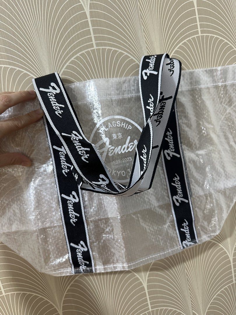 Fender Flagship Tokyo Eco Shopper Bag (Category: Tote Bags) located in Taytay. Submitted by j_r_t (Listing ID 1467183475, Image 3). Description: - 100% Authentic: Official Fender Flagship Tokyo merchandise, brand new with original store tags. - Eye-Catching Design: Clear translucent body featuring the iconic Fender Tokyo Est. 2023 front graphic. - Durable Build: Made of quality polyethylene and polyester with stylish black and white logo webbing 
