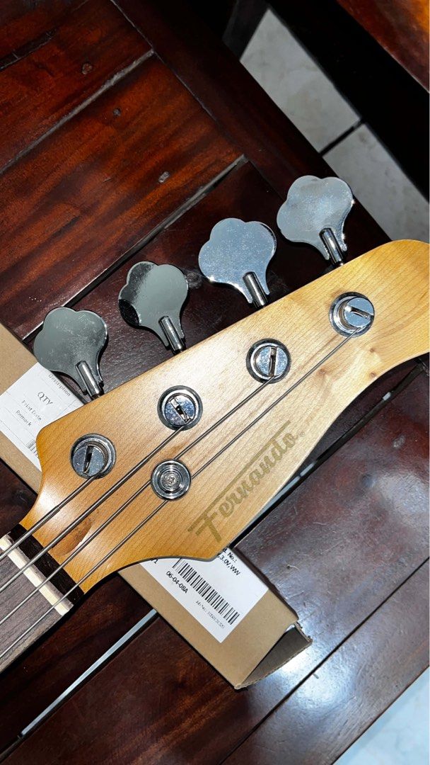 Fernando Bass Guitar with Unnamed Amplifier (Category: Musical Instruments) located in Manila. Submitted by wizteria (Listing ID 1467201105, Image 2). Description: - Brand: Fernando - Type: 4-String Electric Bass Guitar - Color: Black body with white pickguard - Includes: Unnamed practice amplifier - Condition: Used with visible light surface scratches on the body, and some minor rust on hardware/screws (as shown in photos) - Ideal for: Practice,