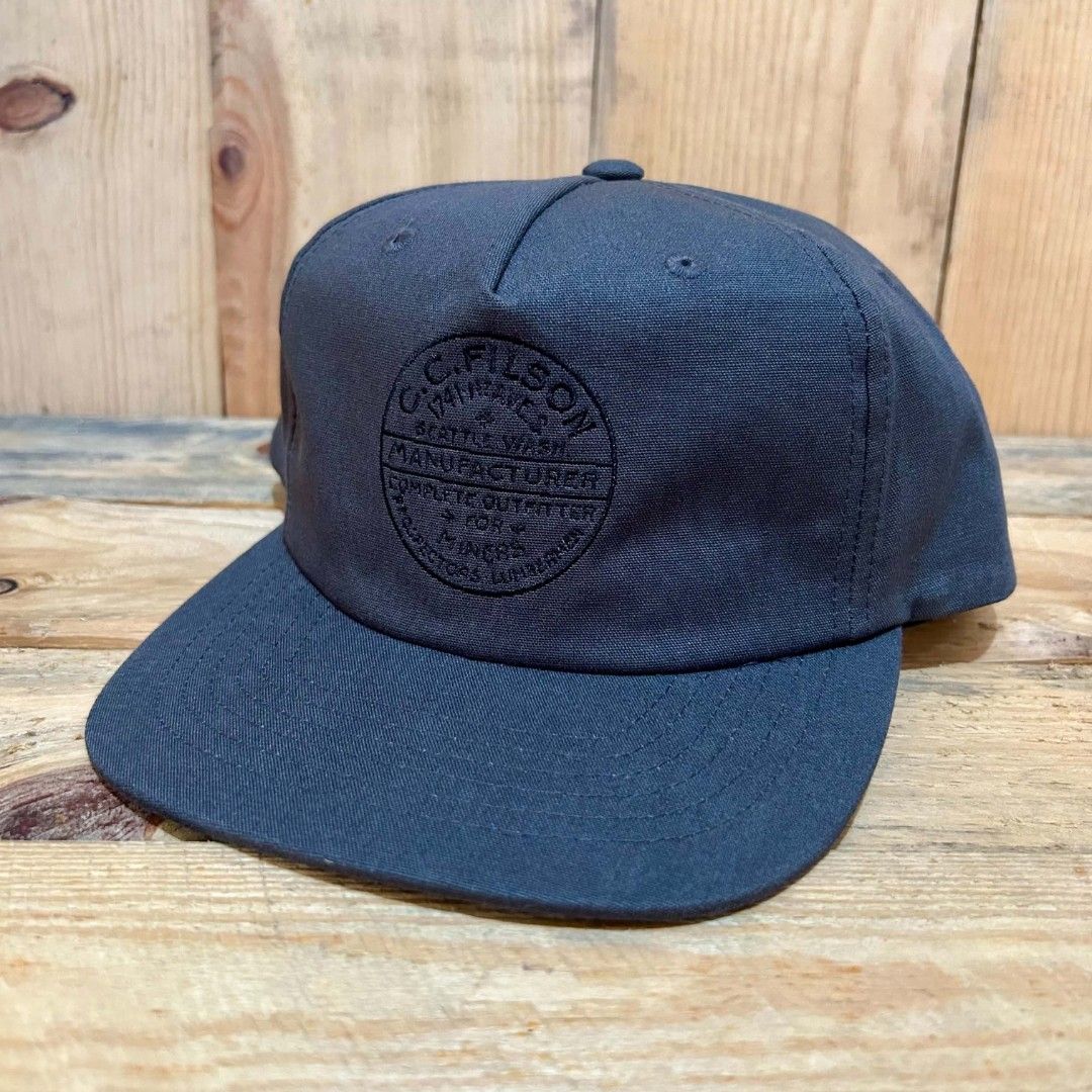 Filson Snapback (Category: Caps & Hats) located in Legazpi City. Submitted by genobecollectives (Listing ID 1467311409, Image 1). Description: Filson snapback 1200 free ship one size fits all - Style: Snapback cap in dark grey - Material: Durable cotton canvas with structured crown panels - Design: Embossed circular logo patch on the front - Closure: Adjustable plastic snapback with Filson branding - Condition: Clean interior lining with original