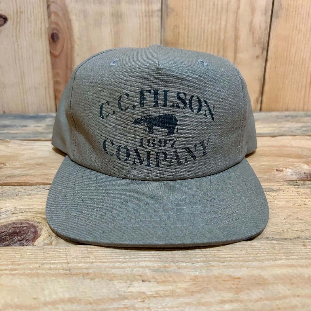 Filson snapback (Category: Caps & Hats) located in Legazpi City. Submitted by genobecollectives (Listing ID 1467311687, Image 1). Description: filson snapback 1000 free ship very good condition my sulatnlng ng ballpen kita sa piks. - Style: Snapback cap with a structured profile and flat brim - Color: Olive green canvas with dark green undervisor - Design: Classic bear graphic and "1897" printed on the front - Materials: 100% cotton shell, 100% p
