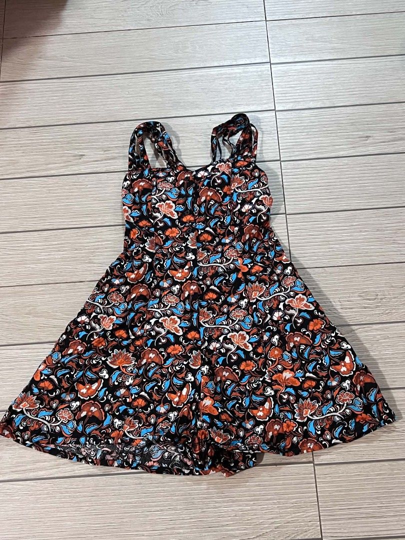 Floral Print Strappy Romper (Category: Rompers) located in San Jose del Monte. Submitted by Skin_Care2022 (Listing ID 1467272650, Image 3). Description: - Style: Black romper with orange, blue, and white floral print - Design: Square neckline, double strap open back, front button closure, and a cute flared skirt overlay - Fabric: Lightweight and breathable, ideal for warm weather - Condition: Worn once, still in great shape.