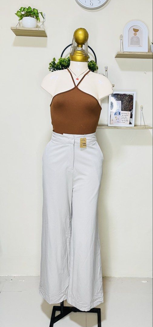 FLYMODEL Off-White High-Waisted Wide Leg Pants (Category: Jeans) located in Manila. Submitted by bengirlclothing (Listing ID 1467177149, Image 1). Description: -SIZE: 27-28 inches -LENGTH: 39 inches -FLYMODEL trousers in light grey or off-white. -High-waisted style with clean front waistband and belt loops. -Smooth fabric, great structure. -Pair with a basic tank or blouse for a clean look..