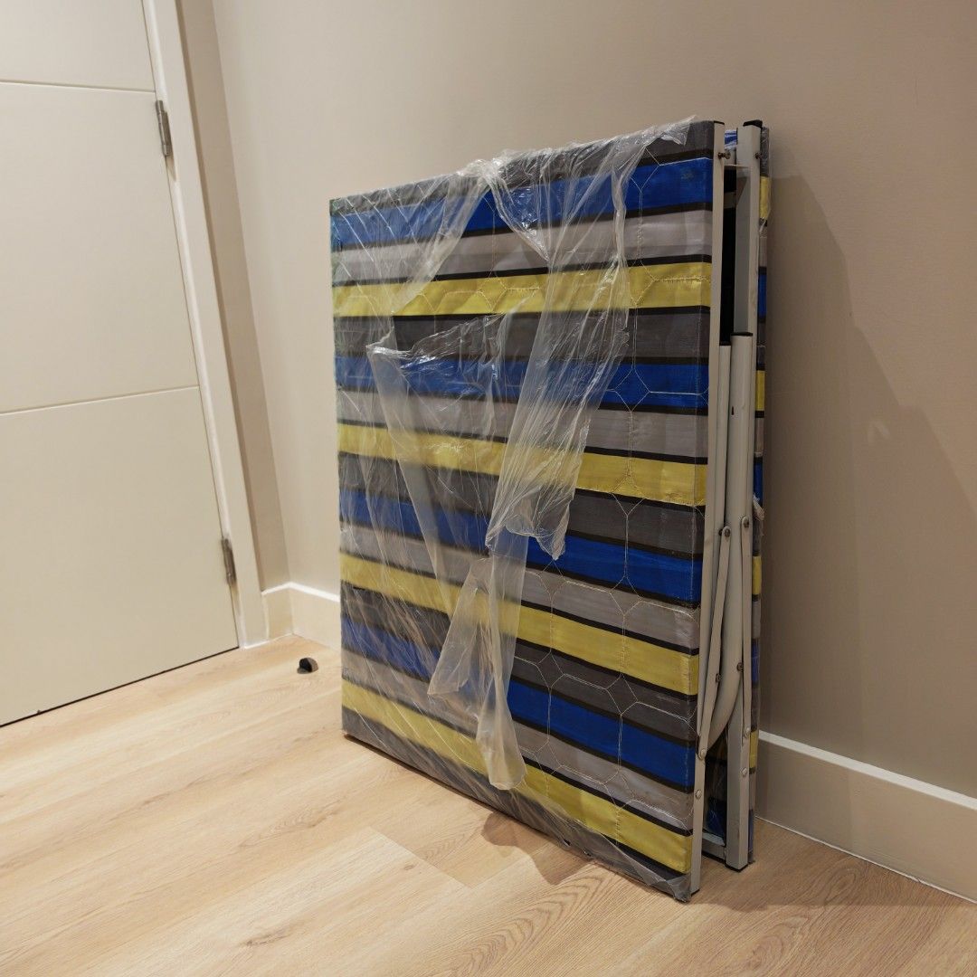 Foldable Single Bed with Blue Striped Mattress (Category: Bed Frames & Mattresses) located in Manila. Submitted by declutterauntie (Listing ID 1467315215, Image 3). Description: - Portable semi single folding bed ***Uratex Mattress 2" thick included*** -White metal frame folds in half for compact storage -Has some rust spots on the frame joints and a minor dent on the metal tubing as pictured Dimensions: When folded 73cm wide x 90 high x 12 thick