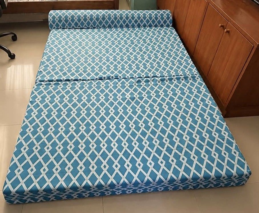 Foldable Sofa Bed (Category: Sofas) located in San Pedro. Submitted by shaaa1003 (Listing ID 1467281094, Image 1). Description: - Design: Stylish blue and white geometric pattern - 2-in-1 Versatility: Easily converts from an upright sofa (with a round backrest pillow) into a flat mattress - Space Saver: Ideal for small apartments, condos, spare rooms, or living spaces - Material: Comfortable high-density foam.