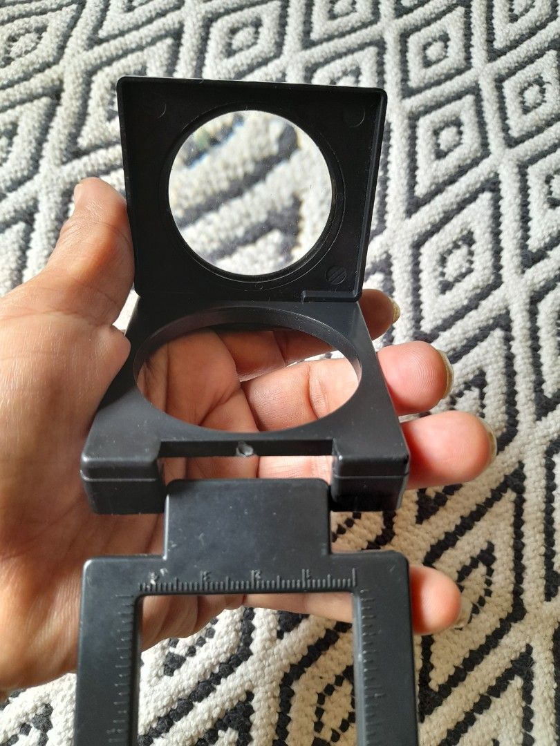 Folding Stand Magnifier with Built-In Measuring Scale (Category: Medical Supplies & Tools) located in Bocaue. Submitted by marajapansurplus (Listing ID 1467194009, Image 3). Description: - Color: Black - Design: Compact 3-panel folding stand that creates a stable square frame - Lens: Clear glass with an integrated measuring scale along the base - Build: Sturdy yet lightweight plastic construction - Portability: Folds completely flat for easy stor