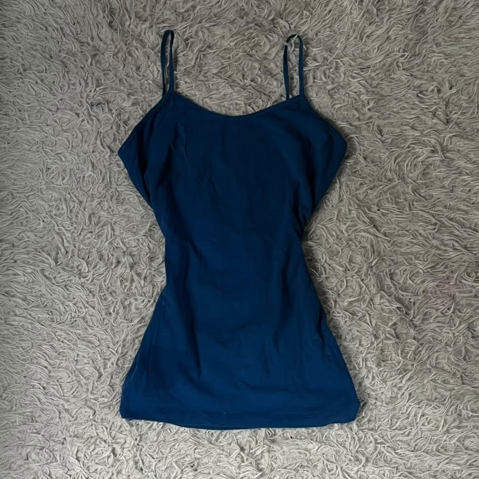 Forever 21 Blue Cami Tank Top (Category: Sleeveless) located in Manila. Submitted by solvithrifts (Listing ID 1467296483, Image 1). Description: - Color: Solid blue - Design: Fitted silhouette with thin adjustable straps - Feature: Built-in shelf bra for extra support - Material: Smooth and stretchy fabric - Versatility: Perfect for layering or wearing on its own - Condition: Clean overall.