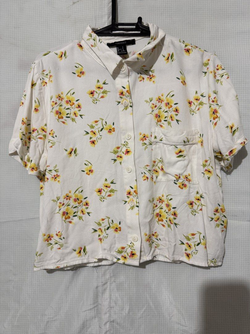 forever 21 floral short sleeve button down blouse (Category: Blouses) located in Quezon City. Submitted by riexomt (Listing ID 1467271962, Image 1). Description: - forever 21 white button-down blouse with floral prints - relaxed loose fit - lightweight and comfortable - perfect with jeans or shorts.