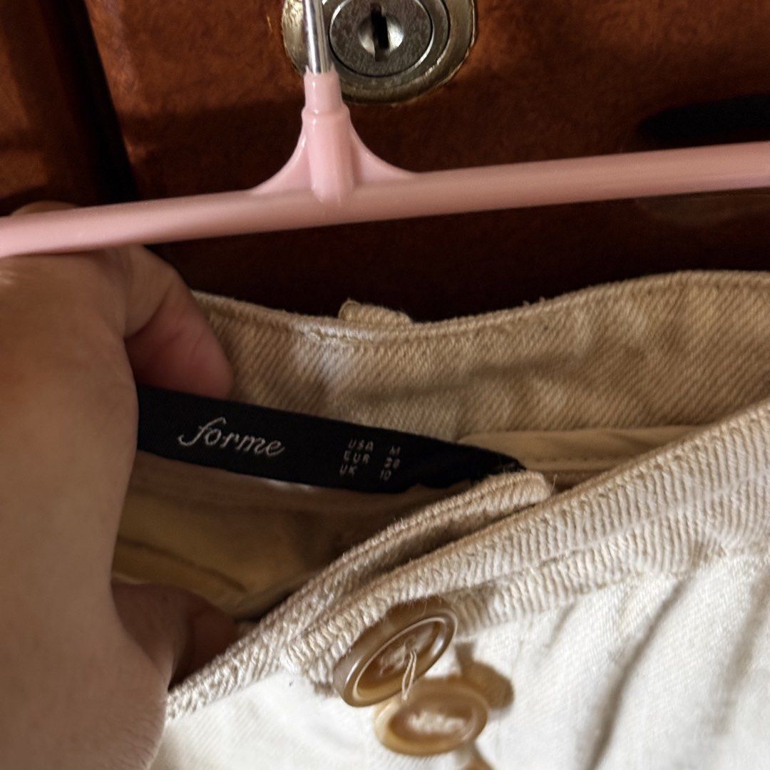 Forme Beige Button-Down Denim Skirt Size M (Category: Skirts) located in Davao. Submitted by keirousel (Listing ID 1467296337, Image 2). Description: - Can be bundled with any item on my listing - Brand: Forme - Size: Medium (EUR 38, UK 10) - Color: Beige - Closure: Front button with 3 brown buttons - Pockets: 2 front pockets - Condition: Clean fabric, normal wear - Style: Versatile daily staple, easy to match with any top.