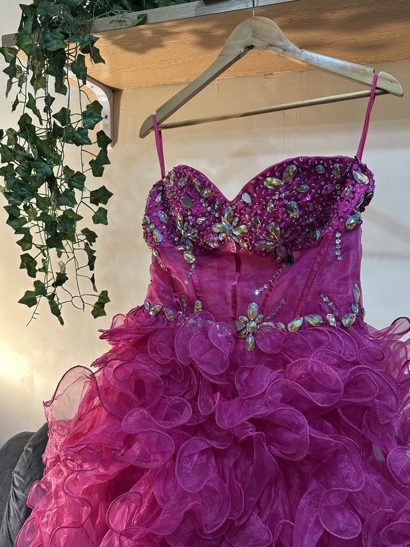 Fuchsia Rhinestone Prom Dress With Ruffles (Category: Evening dresses & gowns) located in Manila. Submitted by tenshiii185 (Listing ID 1467248799, Image 2). Description: - Color: Vibrant fuchsia pink - Design: Strapless with thin spaghetti straps, sweetheart bodice, and waistline heavily embellished with rhinestones - Skirt: Satin base with high-low, voluminous cascading ruffled tulle layers - Closure: Back zipper - Condition: Worn only once, pro