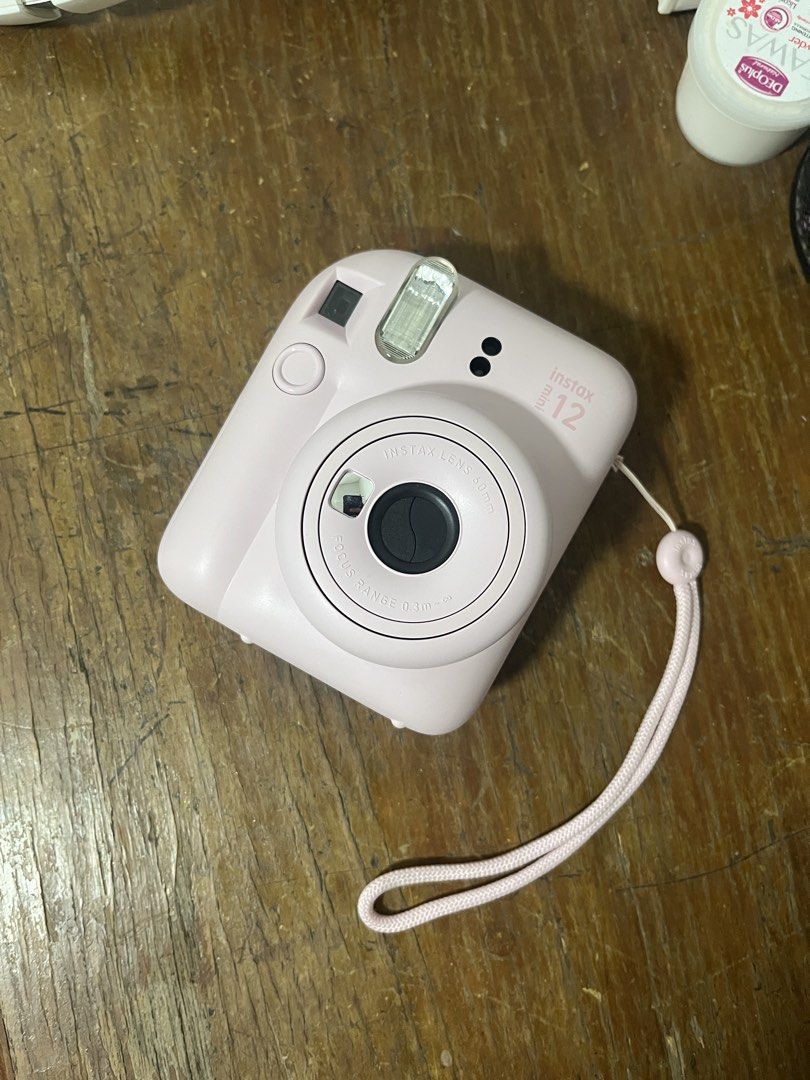 Fujifilm Instax Mini 12 Pink Instant Camera (Category: Cameras) located in Taguig. Submitted by geobuena (Listing ID 1467225536, Image 1). Description: Product: Fujifilm Instax Mini 12 Camera Color: Pastel Pink Bought: 2024 for 5k 📸 Condition: - Rarely used (used only 2-3 times) then has always been stored in my closet - Flash working - Printing still works. Used up my last film last July 2026 to try. - No scratches and dents - No defects ❗️RFS: