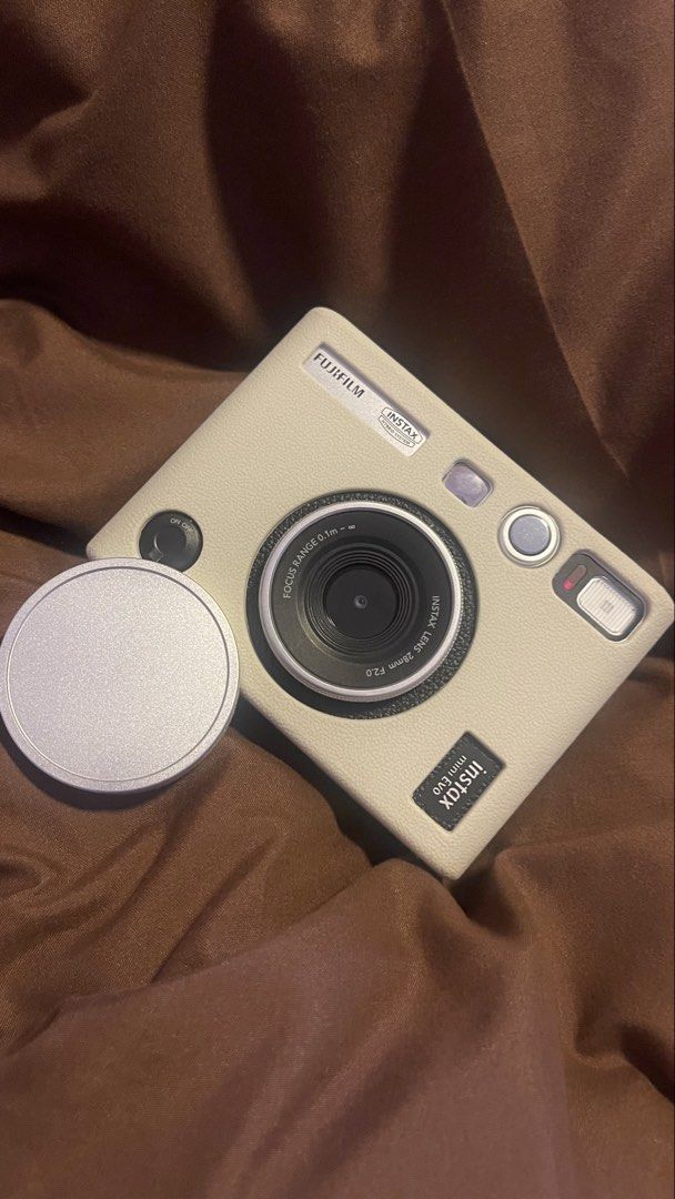 Fujifilm Instax Mini Evo Hybrid Instant Camera with Case (Category: Cameras) located in Manila. Submitted by danicoleons (Listing ID 1467238000, Image 1). Description: - Model: Fujifilm Instax Mini Evo Hybrid Instant Camera (White) - Inclusions: Matching cream leather protective case, lens cap, sd card, box, bag - Features: Digital screen, control buttons, and a classic print lever - Functionality: Shoot digitally, choose filters, and print direc