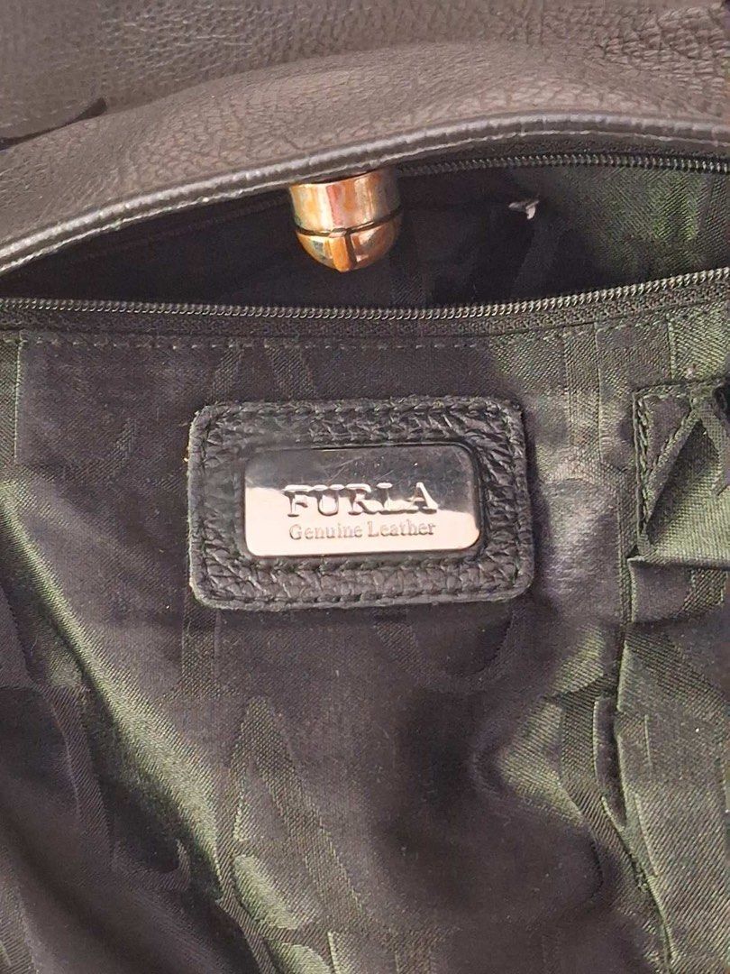 Furla Black Leather Tote Handbag (Category: Luxury Bags & Wallets) located in Muntinlupa City. Submitted by everythingmustgo_8475da (Listing ID 1466970349, Image 2). Description: - Brand: Furla - Material: Genuine black pebbled leather with natural grain texture - Design: Double shoulder handles with secure center turn-lock closure - Interior: Roomy main compartment for all your daily essentials - Craftsmanship: Clean, durable stitching along han