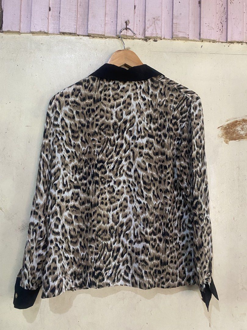 Galliano Italy Leopard Print Silk Blouse (Category: Blouses) located in Manaoag. Submitted by jericsapigao (Listing ID 1467255988, Image 2). Description: - Brand: Galliano Italy - Material: 100% pure silk, lightweight with a smooth finish - Design: Bold leopard print with contrasting black collar and cuffs - Closure: Button-down front - Size: Medium (M tag on collar) - Condition: Excellent, ready to wear.