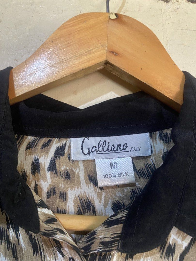 Galliano Italy Leopard Print Silk Blouse (Category: Blouses) located in Manaoag. Submitted by jericsapigao (Listing ID 1467255988, Image 3). Description: - Brand: Galliano Italy - Material: 100% pure silk, lightweight with a smooth finish - Design: Bold leopard print with contrasting black collar and cuffs - Closure: Button-down front - Size: Medium (M tag on collar) - Condition: Excellent, ready to wear.