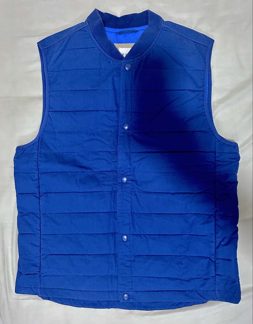 GAP Blue Quilted Puffer Vest (Category: Coats, Jackets and Outerwear) located in Quezon City. Submitted by aussomefinds (Listing ID 1467208913, Image 1). Description: - Brand: Gap - Color: Bright Blue - Size: L - Material: Quilted puffer - Closure: Snap button front - Collar: Ribbed style - Origin: Made in Indonesia - Condition: Great casual layering piece for cooler weather.
