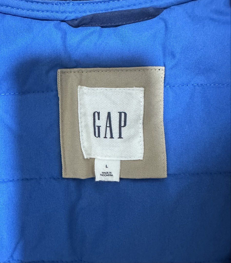 GAP Blue Quilted Puffer Vest (Category: Coats, Jackets and Outerwear) located in Quezon City. Submitted by aussomefinds (Listing ID 1467208913, Image 3). Description: - Brand: Gap - Color: Bright Blue - Size: L - Material: Quilted puffer - Closure: Snap button front - Collar: Ribbed style - Origin: Made in Indonesia - Condition: Great casual layering piece for cooler weather.