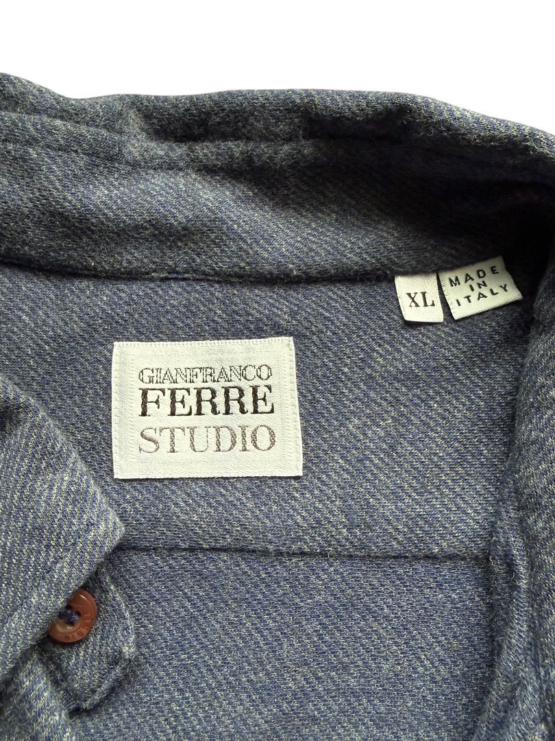 Gianfranco Ferre Studio Long Sleeve Button Down Shirt (Category: Formal Shirts) located in Pasig City. Submitted by hoardwrld (Listing ID 1467178415, Image 3). Description: Width: 19.5 Length: 31 - Brand: Gianfranco Ferre Studio - Style: Long sleeve button-down shirt with button-down collar - Color/Pattern: Blue textured knit fabric with brown buttons - Features: Single chest pocket on the left side - Size: XL - Origin: Made in Italy - Condition: