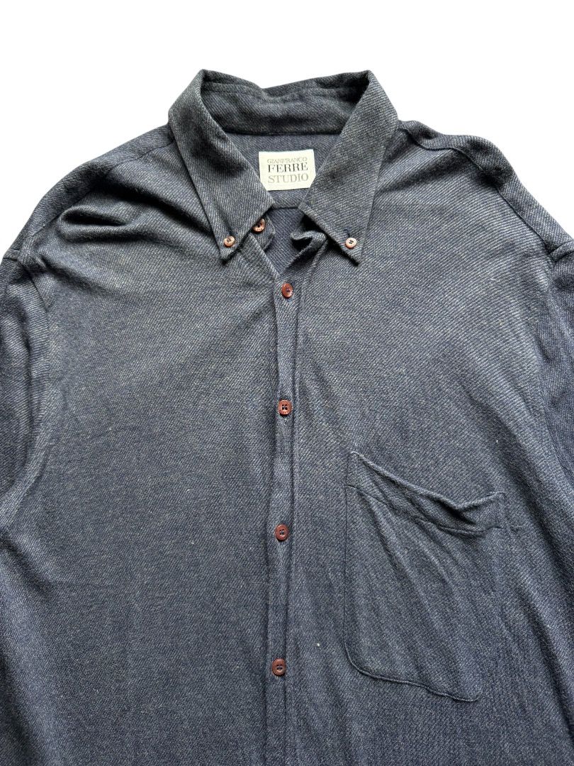 Gianfranco Ferre Studio Long Sleeve Button Down Shirt (Category: Formal Shirts) located in Pasig City. Submitted by hoardwrld (Listing ID 1467178415, Image 2). Description: Width: 19.5 Length: 31 - Brand: Gianfranco Ferre Studio - Style: Long sleeve button-down shirt with button-down collar - Color/Pattern: Blue textured knit fabric with brown buttons - Features: Single chest pocket on the left side - Size: XL - Origin: Made in Italy - Condition: