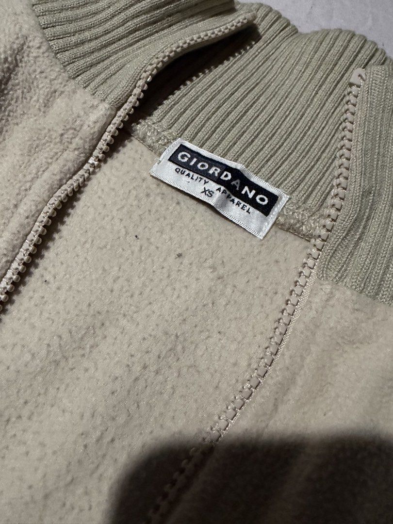 Giordano Beige Fleece Zip-Up Jacket (Category: Coats, Jackets and Outerwear) located in Manila. Submitted by mcllts (Listing ID 1467344156, Image 2). Description: - Brand: Giordano - Color: Cream - Size: XS - Material: Super soft and cozy fleece - Features: Full zip front, ribbed collar and cuffs, two zippered side pockets, and adjustable drawstring hem - Condition: Clean, great layering piece for cold weather NOTE: You can buy 2 other items and 
