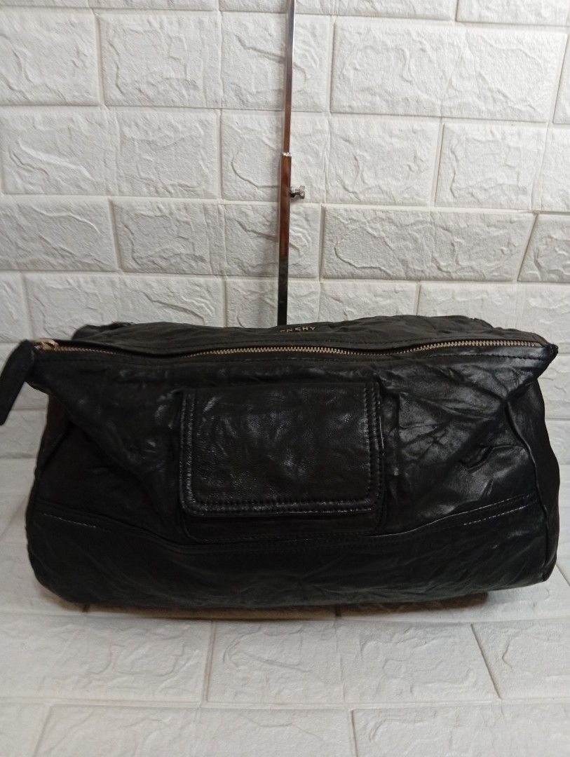 Givenchy Pandora Black Leather 2-way Handbag (Category: Luxury Bags & Wallets) located in Las Pinas. Submitted by etoksi1234 (Listing ID 1467246636, Image 2). Description: Pre-loved Givenchy Pandora black leather handbag with crinkled texture and gold-tone hardware. Features top handles, a detachable shoulder strap, a front magnetic pocket, and a spacious interior..