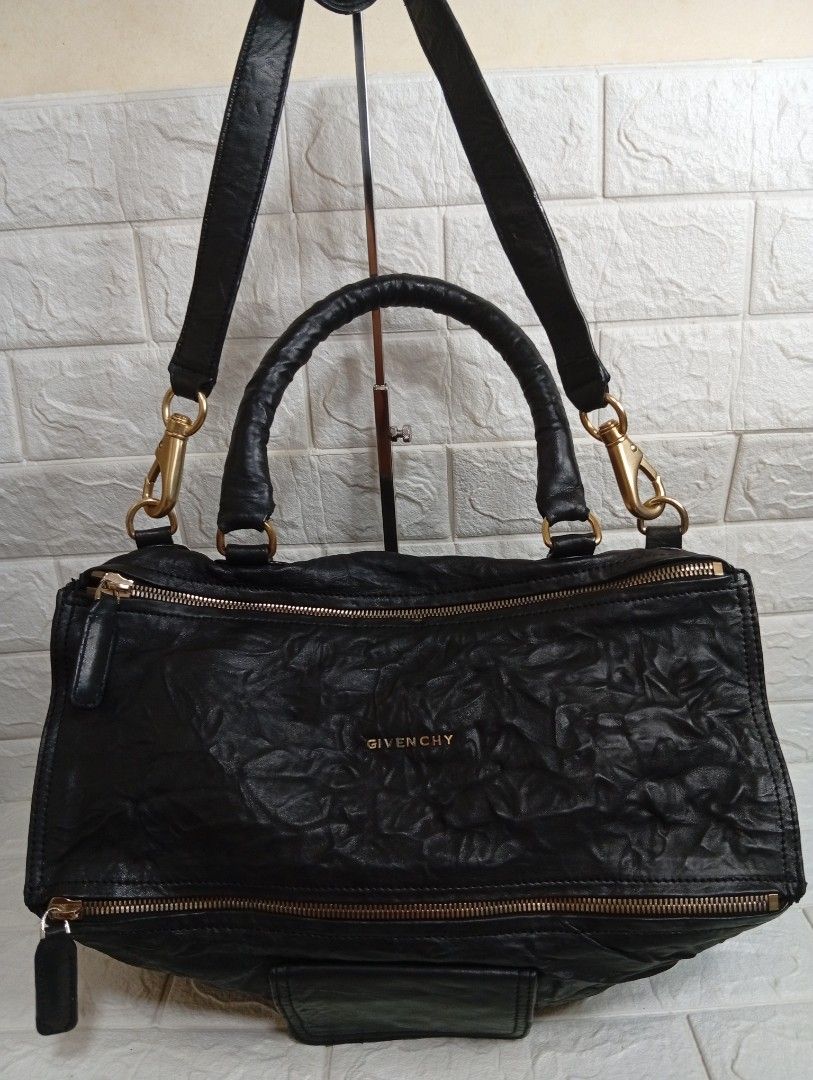Givenchy Pandora Black Leather 2-way Handbag (Category: Luxury Bags & Wallets) located in Las Pinas. Submitted by etoksi1234 (Listing ID 1467246636, Image 1). Description: Pre-loved Givenchy Pandora black leather handbag with crinkled texture and gold-tone hardware. Features top handles, a detachable shoulder strap, a front magnetic pocket, and a spacious interior..