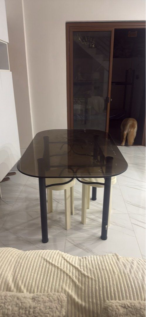Glass Top Dining Table with 4 Stools (Category: Tables & Sets) located in Manila. Submitted by purpiecemanila (Listing ID 1467334241, Image 3). Description: - Sleek smoked glass top with a durable black metal frame and elegant scrollwork - Includes 4 cream-colored plastic stools that tuck neatly underneath to save space - Compact design, perfect for small kitchens, condos, or dining areas - Sturdy construction with minor, normal wear on surfaces 