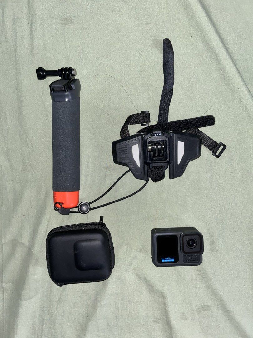 GoPro Hero action camera with floating handle and Telesin mount (Category: Video Cameras) located in Manila. Submitted by watchap.ketchup (Listing ID 1467255660, Image 1). Description: - Complete GoPro action camera setup, perfect for action sports, vlogging, and outdoor trips - Includes: GoPro camera body, black protective case, and wrist strap - Orange and black floating hand grip included (great for water activities) - Comes with a Telesin hel