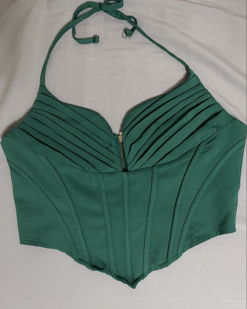 Green Halter Corset Top Ruched Bustier (Category: Sleeveless) located in Quezon City. Submitted by j.steffy (Listing ID 1467326248, Image 1). Description: - Color: Emerald green - Style: Halter top with pleated bust detail - Closure: Front zipper - Fit: Structured boning throughout the bodice for a flattering silhouette - Features: Adjustable neck straps.