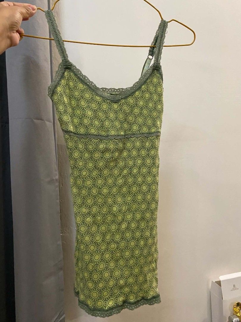 Green patterned cami top with lace trim (Category: Sleeveless) located in Malasiqui. Submitted by finnley26 (Listing ID 1467246517, Image 2). Description: - Color: Green with repeating circular pattern - Material: Lightweight, stretchy ribbed fabric - Features: Adjustable shoulder straps, delicate lace trim on neckline and hem - Design: Empire waist with metallic sheen trim - Styling: Great for layering or wearing on its own - Condition: Brand ne