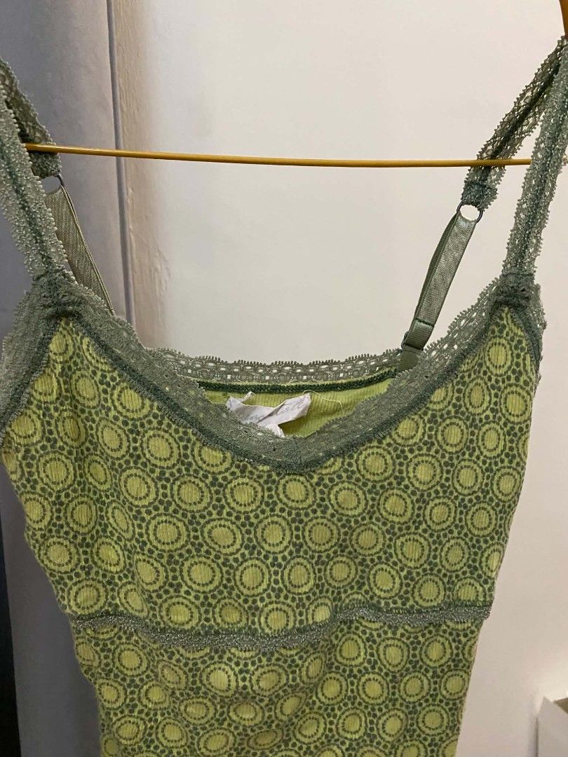 Green patterned cami top with lace trim (Category: Sleeveless) located in Malasiqui. Submitted by finnley26 (Listing ID 1467246517, Image 1). Description: - Color: Green with repeating circular pattern - Material: Lightweight, stretchy ribbed fabric - Features: Adjustable shoulder straps, delicate lace trim on neckline and hem - Design: Empire waist with metallic sheen trim - Styling: Great for layering or wearing on its own - Condition: Brand ne