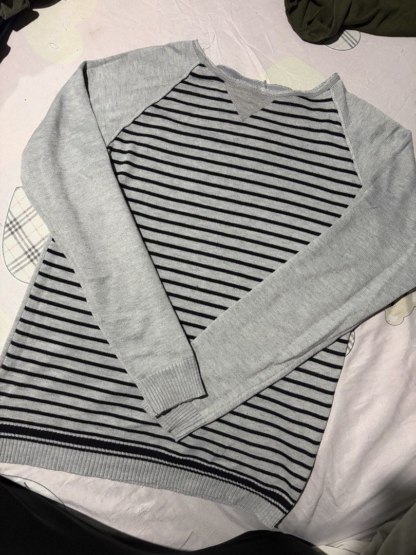 Grey and Black Striped Long Sleeve Sweater (Category: Longsleeves) located in Manila. Submitted by mcllts (Listing ID 1467341005, Image 1). Description: - Color & Pattern: Classic grey with horizontal black stripes - Design: Scoop neckline with a stylish front triangle insert patch - Sleeves & Fit: Long raglan sleeves with ribbed cuffs and hem, standard fit - Material: Lightweight knit, ideal for layering during cooler weather - Style: Versatile 