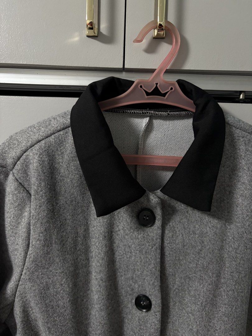 Grey Button-Up Jacket with Black Collar (Category: Coats, Jackets and Outerwear) located in Imus. Submitted by _monicakes (Listing ID 1467168978, Image 2). Description: - Color: Grey with contrasting black lapel collar - Design: Button-up front with dark buttons and front pockets - Fit: Structured look with a plain back - Feature: Perfect layering piece for cooler weather - Condition: Excellent.