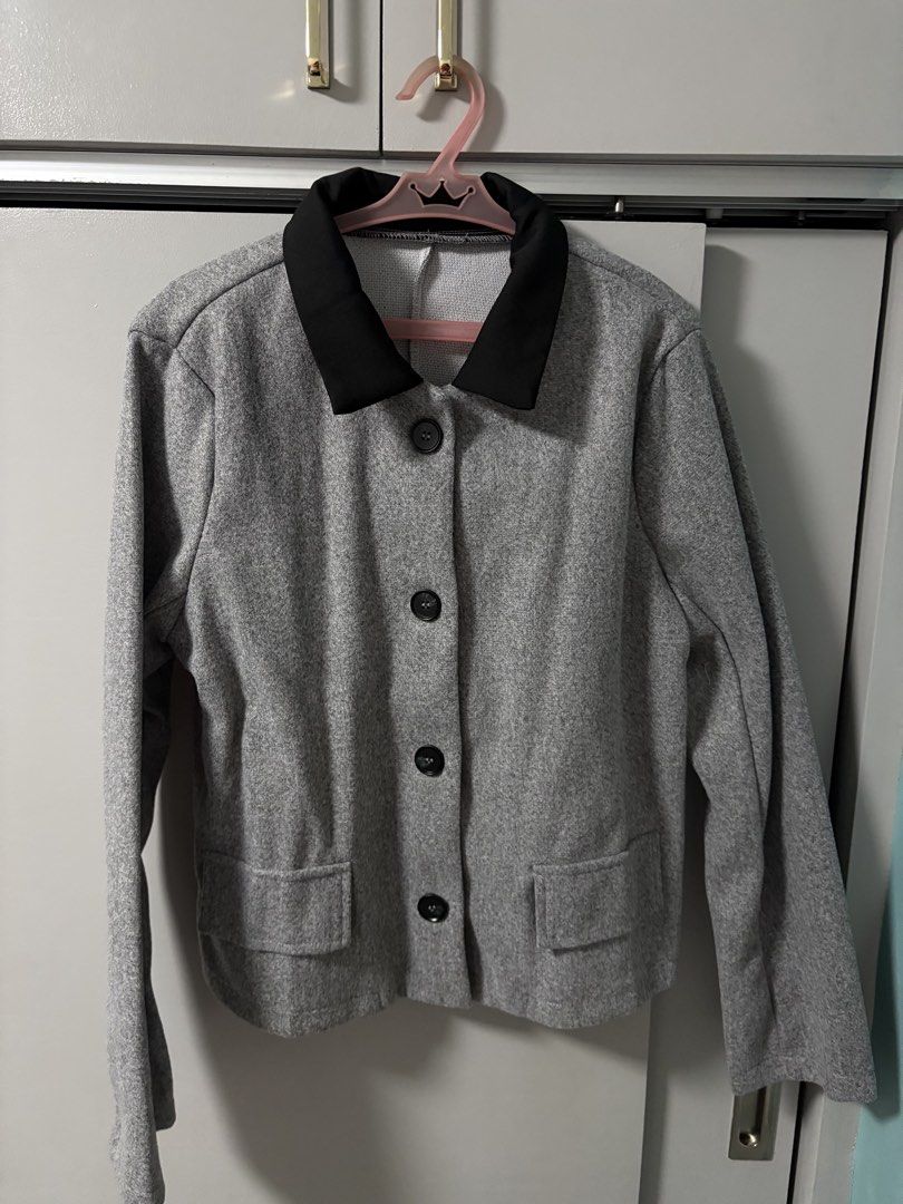 Grey Button-Up Jacket with Black Collar (Category: Coats, Jackets and Outerwear) located in Imus. Submitted by _monicakes (Listing ID 1467168978, Image 1). Description: - Color: Grey with contrasting black lapel collar - Design: Button-up front with dark buttons and front pockets - Fit: Structured look with a plain back - Feature: Perfect layering piece for cooler weather - Condition: Excellent.
