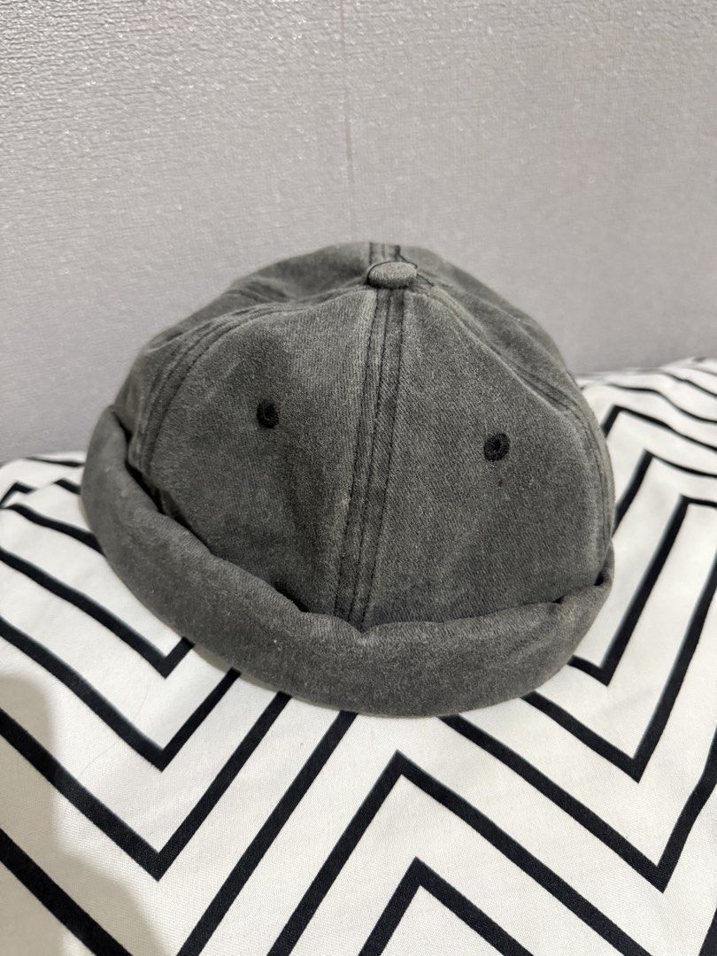 Grey Docker Cap Brimless Hat Miki Hat (Category: Caps & Hats) located in Rizal. Submitted by ivagabond (Listing ID 1467216420, Image 3). Description: - Style: Brimless docker cap / fisherman cap - Color: Grey washed - Material: 100% breathable cotton - Features: Stitched panels, embroidered eyelets, and clean interior taping - Fit: Adjustable back strap with a secure metal buckle - Condition: Brand new - Bought from Shein.
