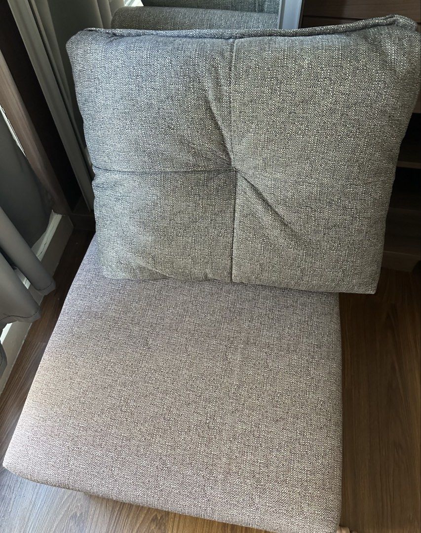 Grey fabric sofa with chaise lounge (Category: Sofas) located in Manila. Submitted by niftyshopper017 (Listing ID 1467351132, Image 2). Description: - Color/Material: Neutral grey textured woven fabric - Comfort: Deep seat design, ideal for lounging - Includes: Back cushions and a separate matching chair - Condition: Clean and well-maintained - Reason for selling: Moving house, quick sale needed - Fulfillment: Pickup only.