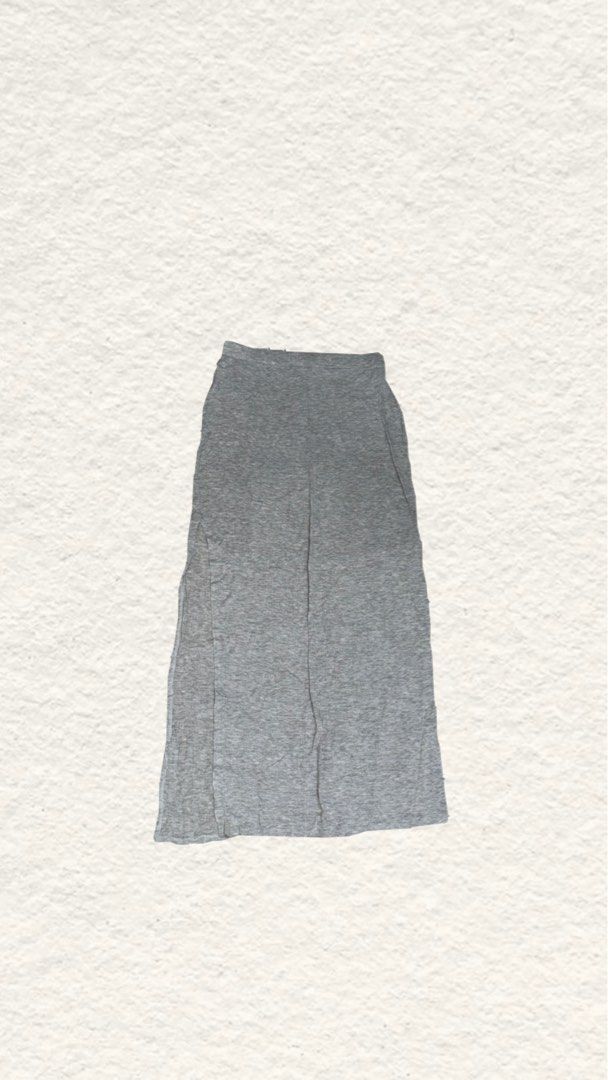 Grey Long Cotton Skirt with Side Slit (Category: Skirts) located in Quezon City. Submitted by zealhorse_a9f3c3 (Listing ID 1467344278, Image 1). Description: - Color: Grey - Style: Long maxi skirt with a straight cut design - Material: Soft and comfortable jersey - Waistband: Stretchable elastic for a great fit - Feature: High slit on one side for easy walking - Versatility: Perfect basic piece to match with t-shirts and crop tops for casual ever