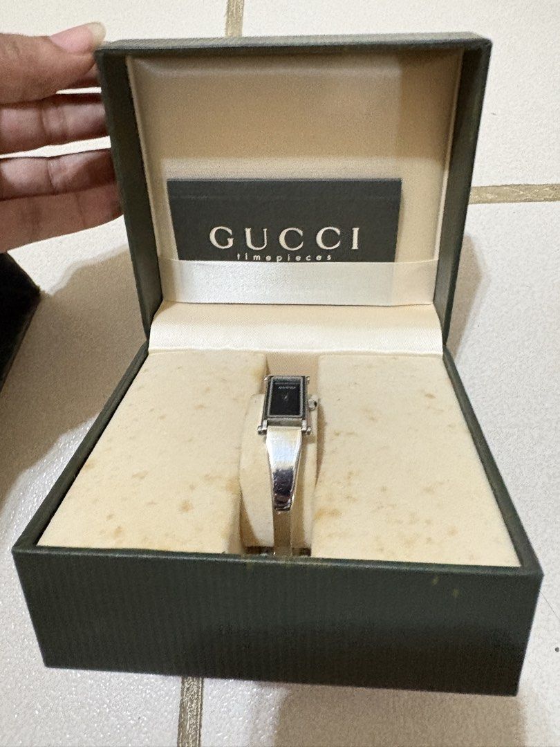 Gucci 1500L watch silver black dial (Category: Luxury Watches) located in Calamba. Submitted by angelliramosss (Listing ID 1467327288, Image 1). Description: - 100% Authentic Gucci rectangular watch - Chic minimalist design with a sleek black face/dial - Elegant silver-tone bangle strap - Includes original dark green Gucci box, interior branding, and watch pillow - Perfect accessory for daily wear or formal occasions Bought in Japan.