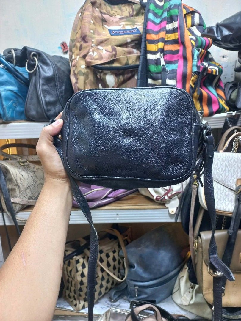 Gucci Interlocking G Leather Shoulder Bag (Category: Luxury Bags & Wallets) located in Manila. Submitted by del_thrifts03 (Listing ID 1467349686, Image 2). Description: - Color & Material: Dark navy blue textured leather - Brand Detail: Large embossed Interlocking G logo on the front - Interior: Cream fabric lining w ith a convenient slip pocket - Hardware & Strap: Metal rings with an adjustable crossbody strap - Closure: Secure top zip closure -